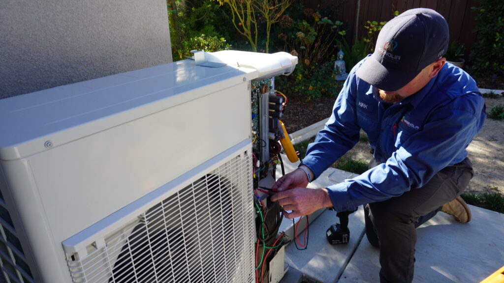 tech working on heat pump